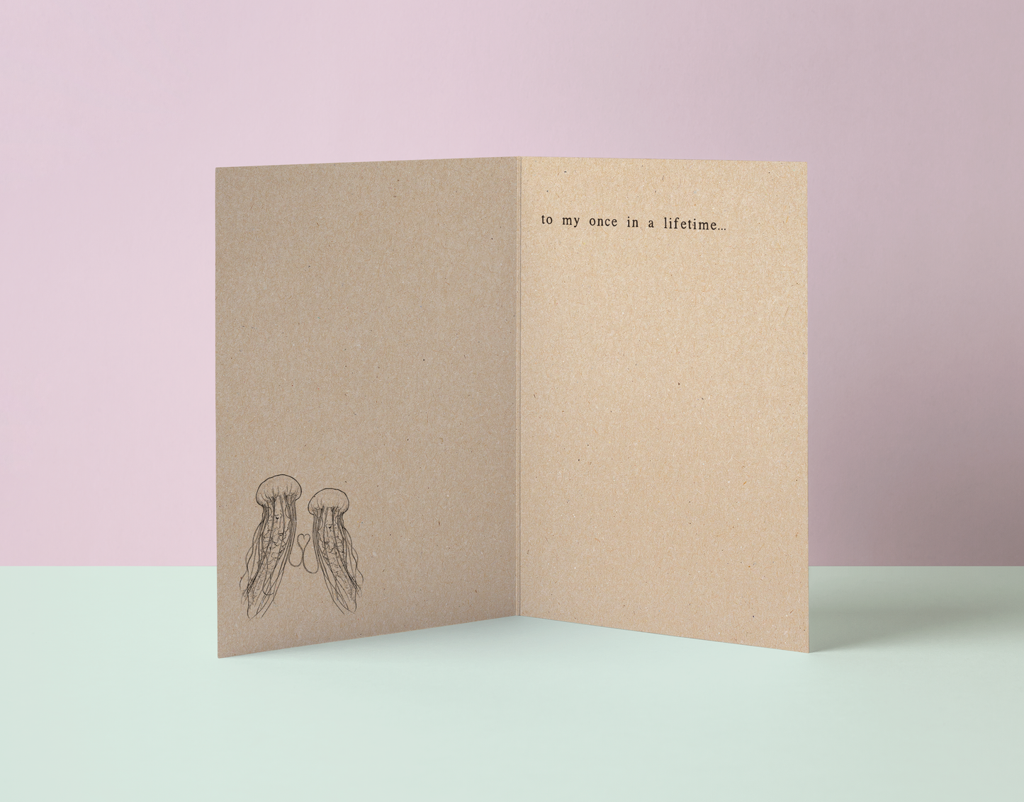 Folded kraft recycled card with jellyfish illustration and text saying to my once in a lifetime poetry.