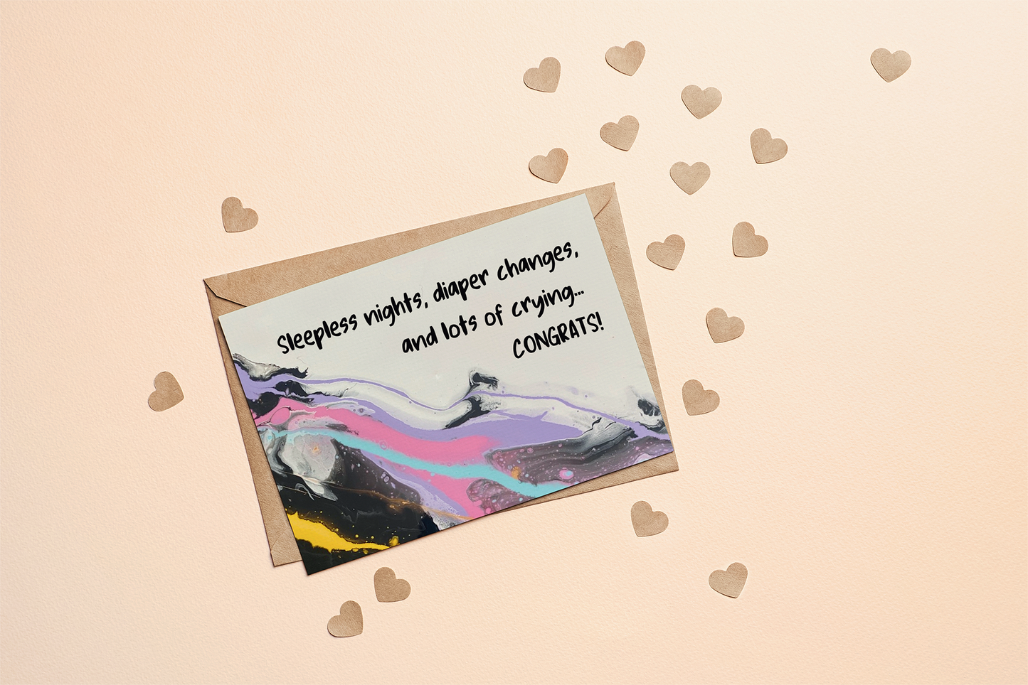 Greeting card with colourful abstract design and humourous text - Sleepless nights, diaper changes and lots of crying..Congrats! on a white background with brown envelope.