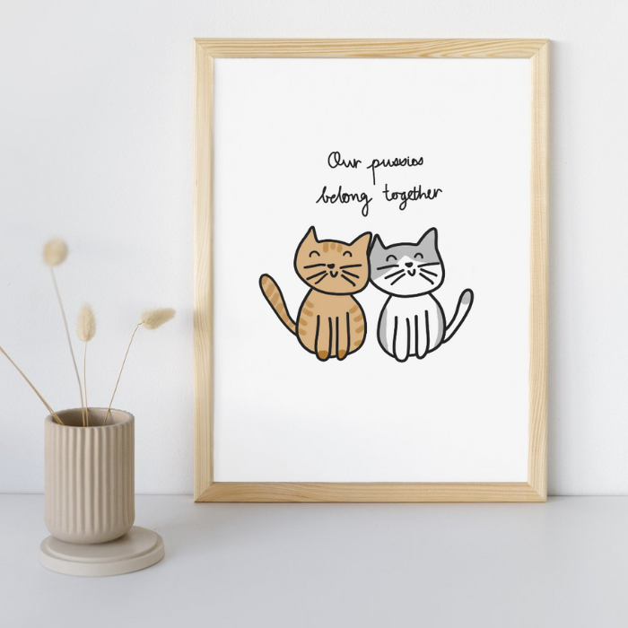 Our Pussies Belong Together Fine Art Print in a Sandy Timber Frame sitting against wall on desk.