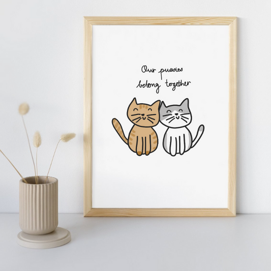 Our Pussies Belong Together Fine Art Print in a Sandy Timber Frame sitting against wall on desk.