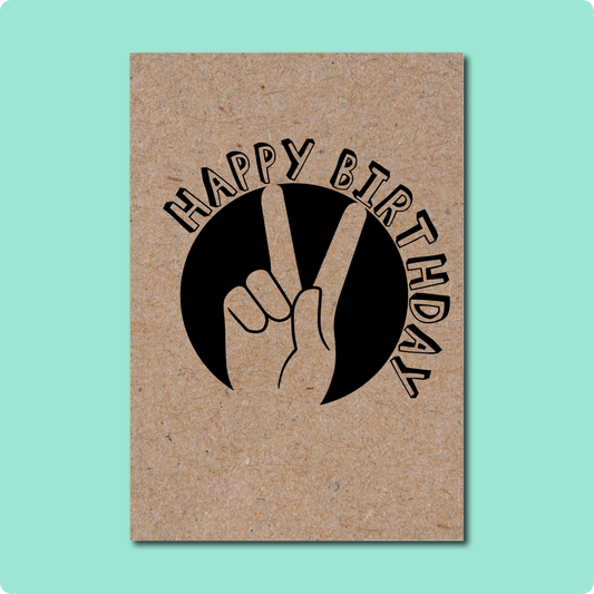 Happy Birthday Peace Sign Card on Australian recycled Kraft Brown paper with black font of hand peace sign in sun with curvature happy birthday font