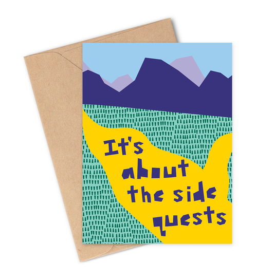 Greeting card with mountain design and text 'It's about the side quests' on a white background