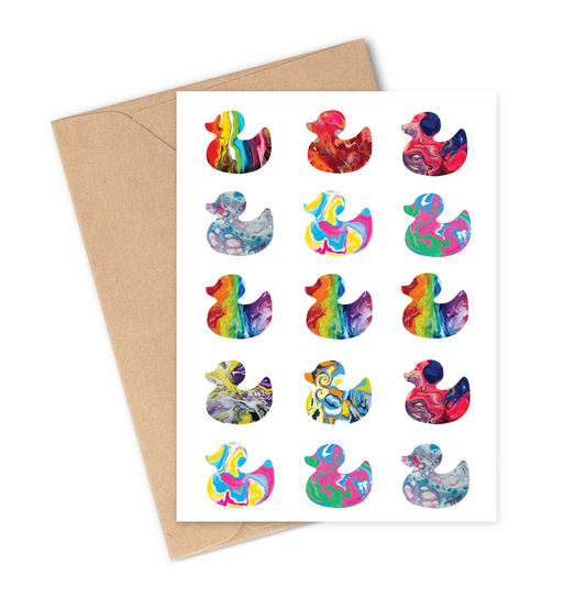 Greeting card with colourful pride duck illustrations featuring pride flag colours - progress pride, trans, lesbian, bisexual, pansexual, polysexual, rainbow, aroace and non-binary on a white background with brown envelope.