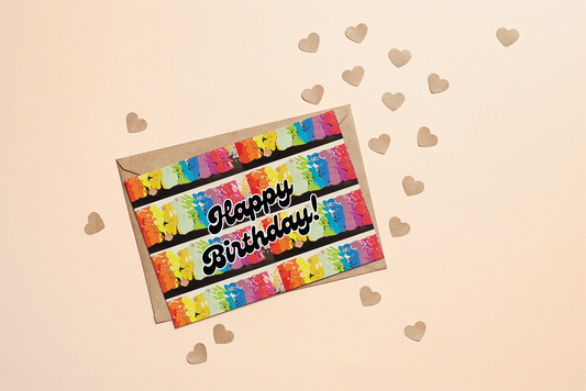 Colourful rainbow birthday card with 'Happy Birthday!' text on a beige background with heart decorations.