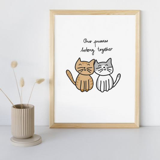 Our Pussies Belong Together Fine Art Print in a Sandy Timber Frame sitting against wall on desk. 