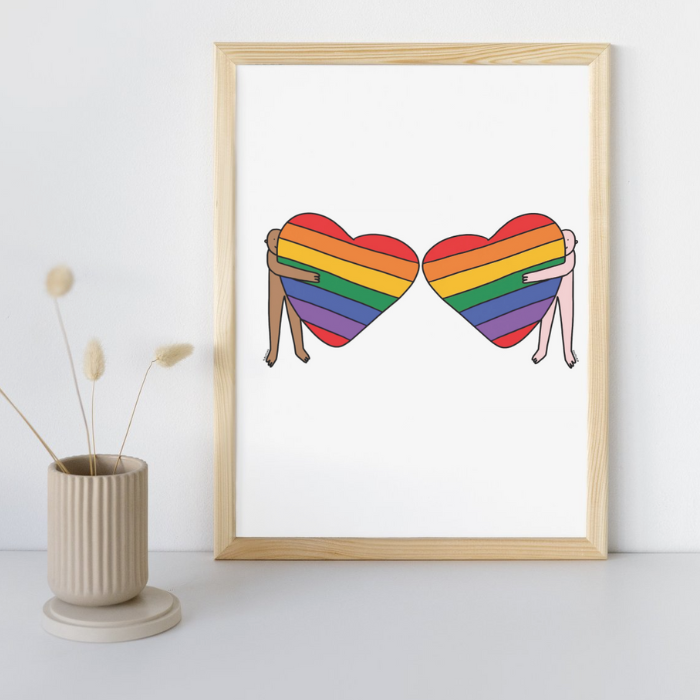 Rainbow Heart Hugs POC & Pinkie Pride A4 Fine Art Print on minimalist desk. 